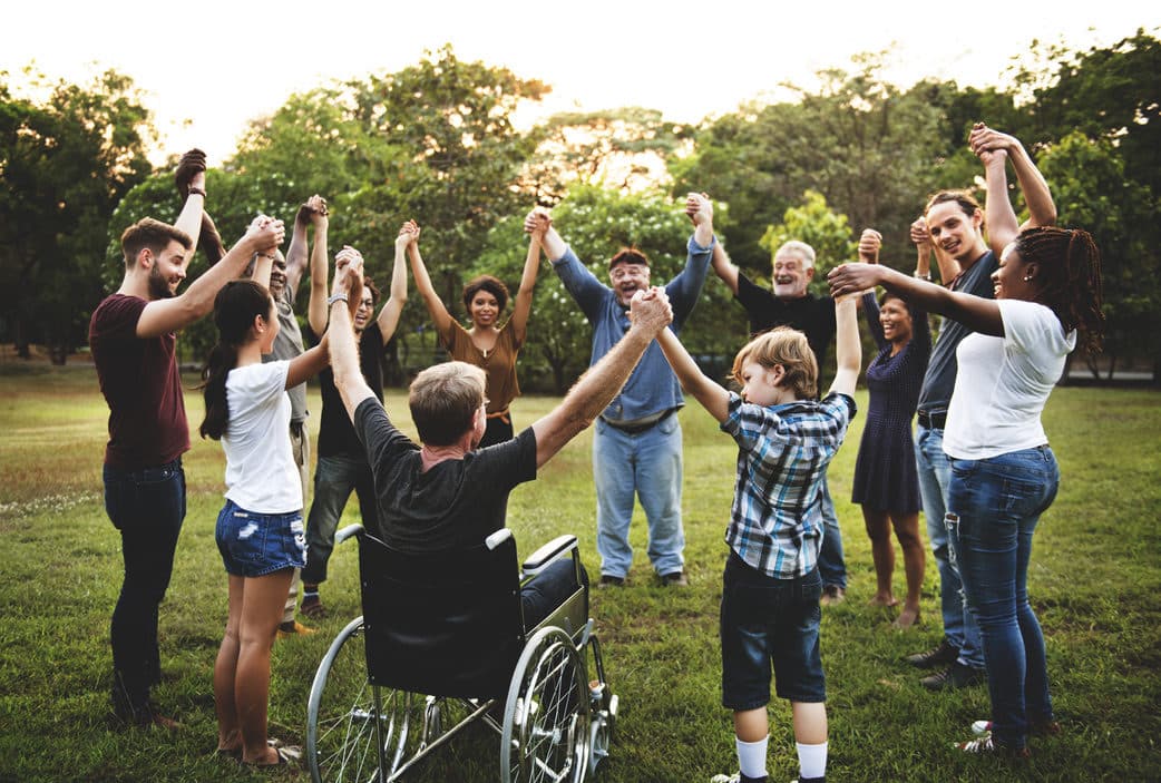 Group of people holding hand together in the park